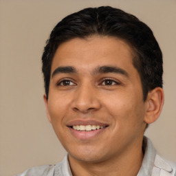 Joyful latino young-adult male with short  black hair and brown eyes