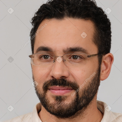 Joyful white adult male with short  black hair and brown eyes