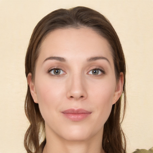 Joyful white young-adult female with long  brown hair and brown eyes