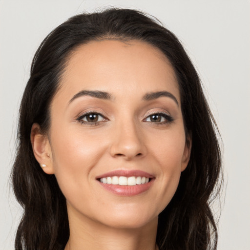 Joyful white young-adult female with long  brown hair and brown eyes