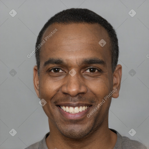 Joyful black adult male with short  black hair and brown eyes