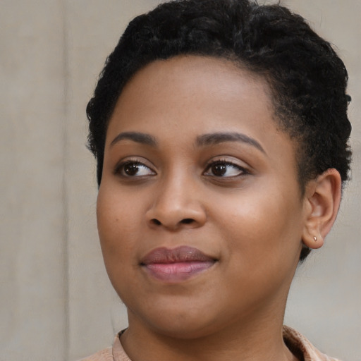 Joyful black young-adult female with short  black hair and brown eyes