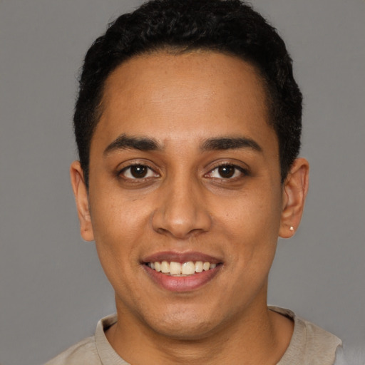 Joyful latino young-adult female with short  black hair and brown eyes