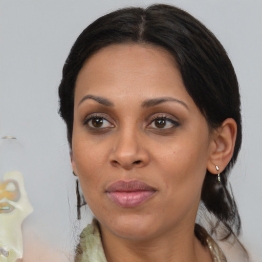 Joyful black adult female with medium  brown hair and brown eyes