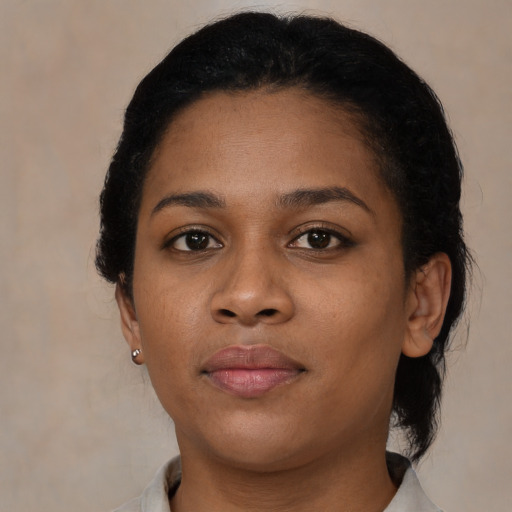 Neutral black young-adult female with medium  brown hair and brown eyes