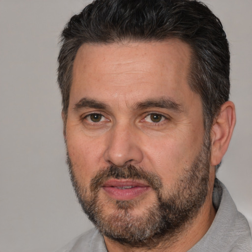 Joyful white adult male with short  brown hair and brown eyes