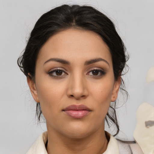 Joyful latino young-adult female with medium  brown hair and brown eyes