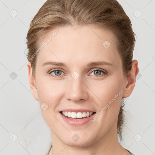 Joyful white young-adult female with medium  brown hair and grey eyes