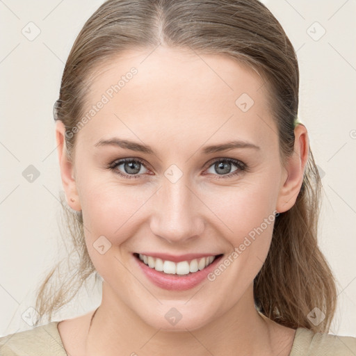 Joyful white young-adult female with medium  brown hair and blue eyes