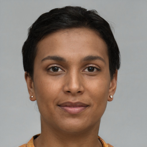 Joyful latino young-adult female with short  brown hair and brown eyes