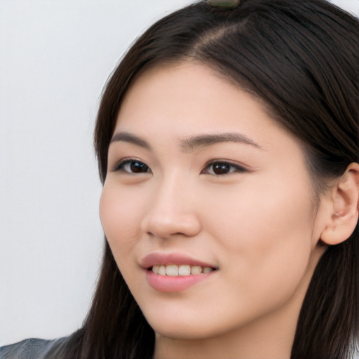 Joyful white young-adult female with long  black hair and brown eyes