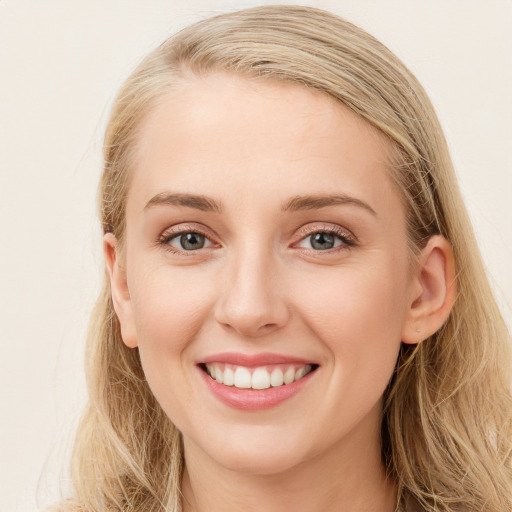 Joyful white young-adult female with long  brown hair and blue eyes