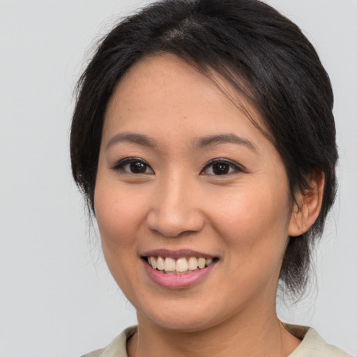 Joyful white young-adult female with medium  brown hair and brown eyes