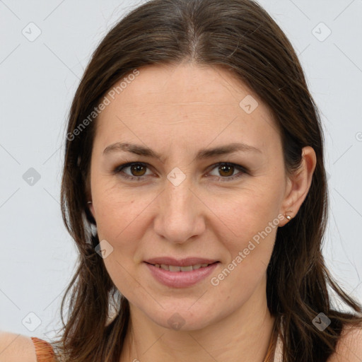 Joyful white adult female with long  brown hair and brown eyes