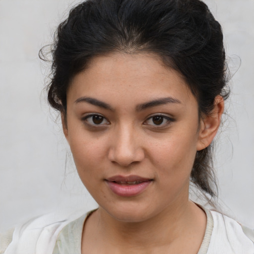 Joyful latino young-adult female with medium  brown hair and brown eyes