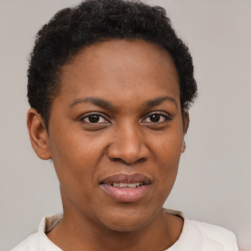Joyful black young-adult female with short  brown hair and brown eyes