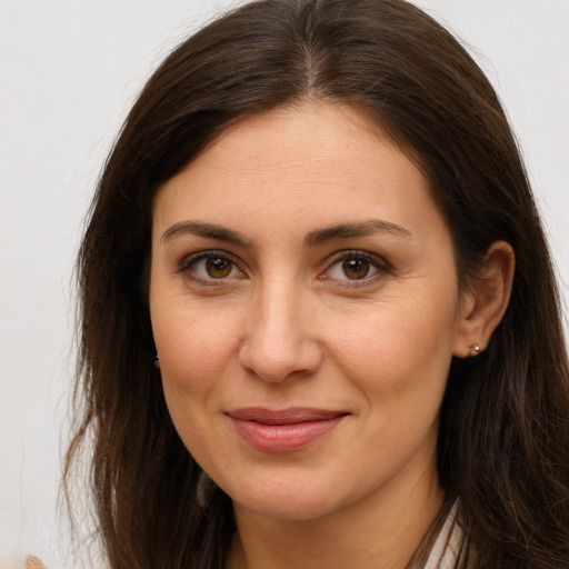 Joyful white young-adult female with long  brown hair and brown eyes