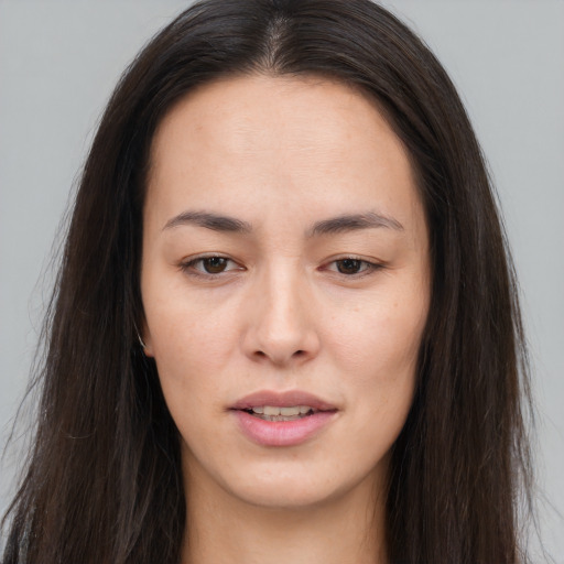 Joyful asian young-adult female with long  brown hair and brown eyes