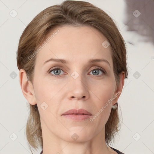 Joyful white adult female with medium  brown hair and grey eyes