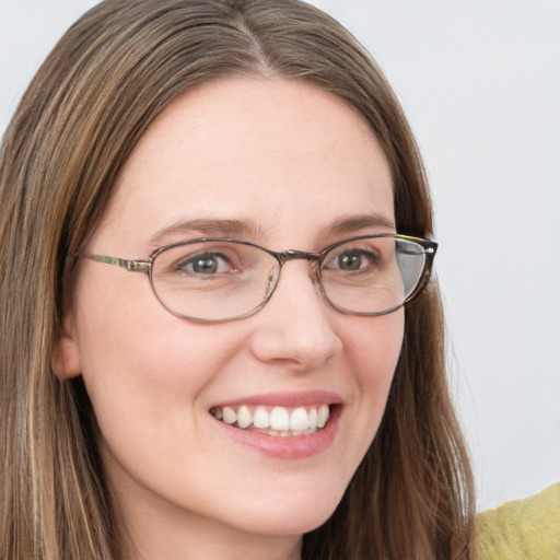 Joyful white young-adult female with long  brown hair and blue eyes