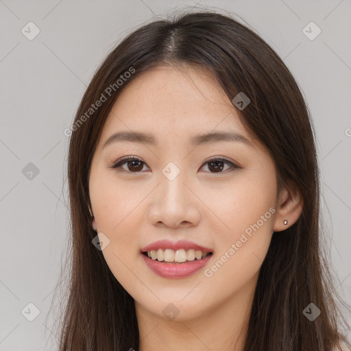 Joyful asian young-adult female with long  brown hair and brown eyes