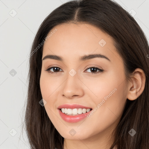 Joyful white young-adult female with long  brown hair and brown eyes