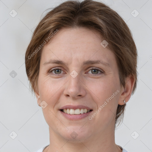 Joyful white adult female with short  brown hair and grey eyes