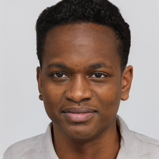 Joyful black young-adult male with short  black hair and brown eyes