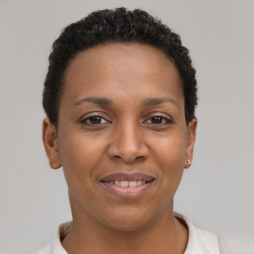 Joyful black young-adult female with short  brown hair and brown eyes