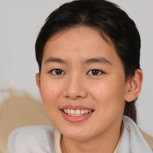 Joyful asian young-adult female with medium  brown hair and brown eyes