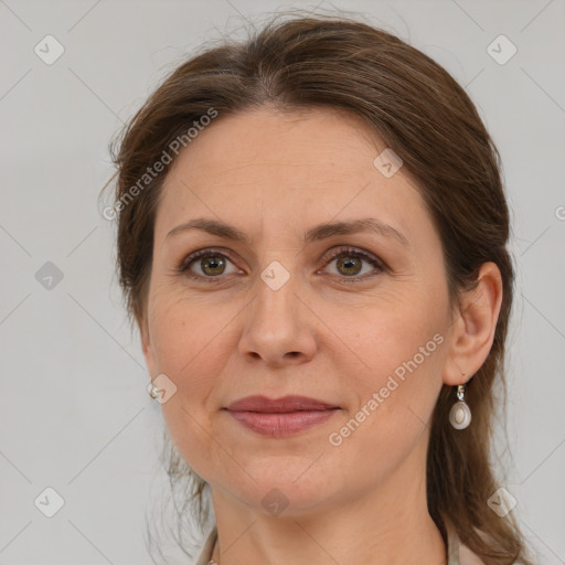 Joyful white adult female with medium  brown hair and grey eyes