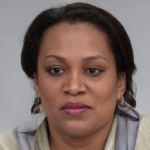 Joyful latino adult female with medium  brown hair and brown eyes