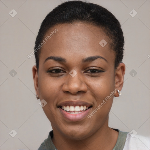 Joyful black young-adult female with short  black hair and brown eyes