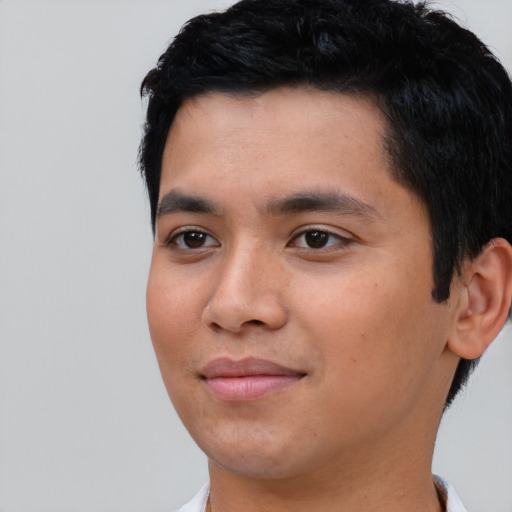 Joyful asian young-adult male with short  black hair and brown eyes