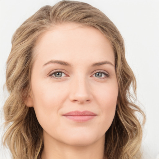 Joyful white young-adult female with long  brown hair and blue eyes