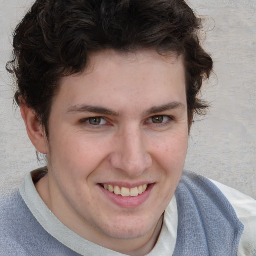 Joyful white young-adult male with short  brown hair and blue eyes