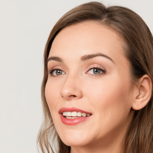 Joyful white young-adult female with long  brown hair and blue eyes