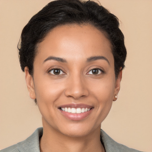 Joyful latino young-adult female with short  brown hair and brown eyes