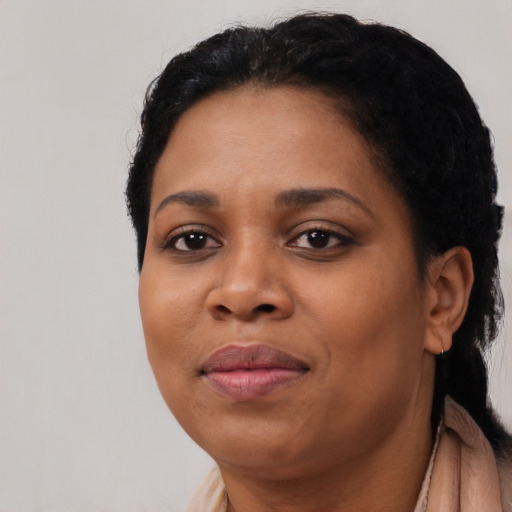 Joyful black adult female with short  black hair and brown eyes