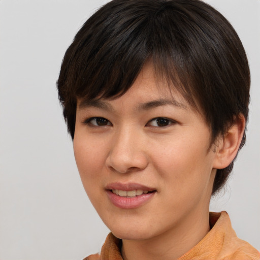 Joyful asian young-adult female with short  brown hair and brown eyes