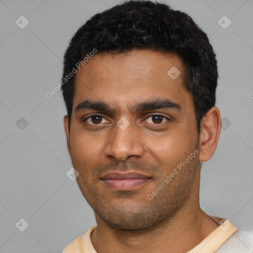 Joyful black young-adult male with short  black hair and brown eyes