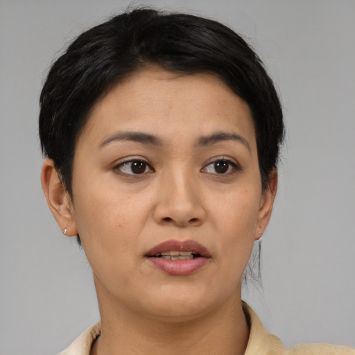 Joyful asian young-adult female with short  black hair and brown eyes