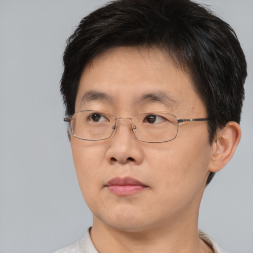Neutral asian adult male with short  brown hair and brown eyes