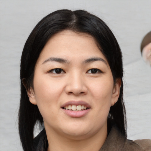 Joyful asian young-adult female with medium  black hair and brown eyes