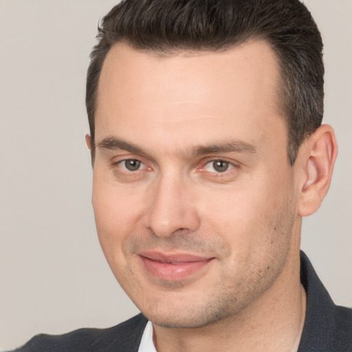 Joyful white adult male with short  brown hair and brown eyes