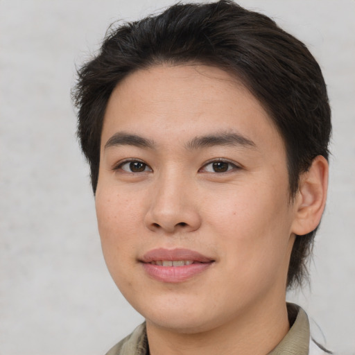 Joyful asian young-adult female with short  brown hair and brown eyes