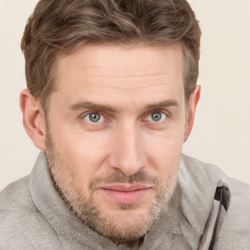 Joyful white adult male with short  brown hair and grey eyes