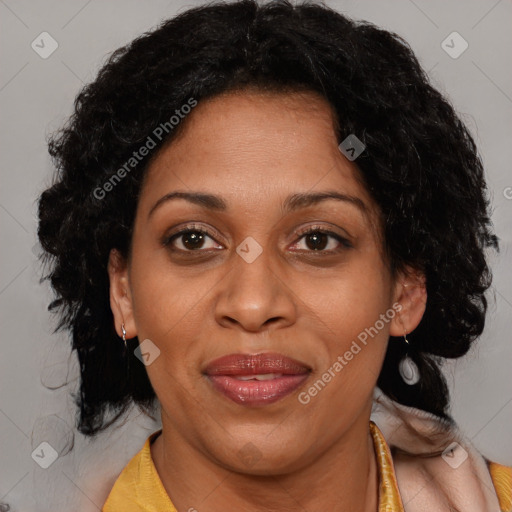 Joyful black adult female with medium  brown hair and brown eyes