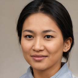 Joyful asian young-adult female with medium  brown hair and brown eyes