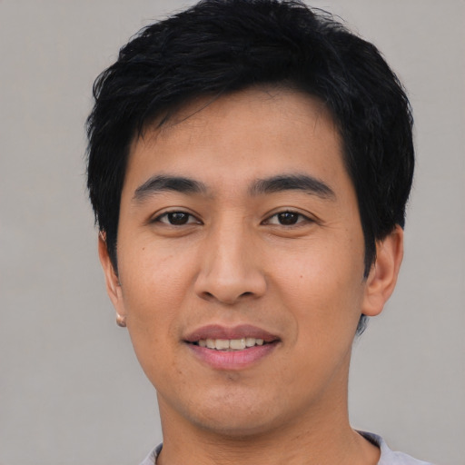 Joyful asian young-adult male with short  black hair and brown eyes